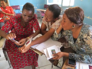 Tanzanian nurses (left to right) Nice Moshi, Fulgencia Mvulla, and Gladys Tumbo examine images at a cervical cancer screening refresher training in Dodoma.