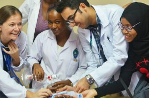 Aliasgar Khaki (second from right) practicing neonatal resuscitation in course taught by GHSP Physician Educator Esther Johnston (left).