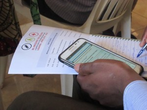 Multi-tasking – conference participant with smartphone using UpToDate clinical support software.