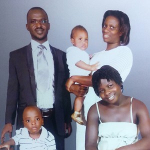 Sam Olum (left) with his wife Resty Katushabe (standing) holding their son Josiah Tim. Seated in front are their older son Jonathan Rwotgene and Sam's cousin Sunday Aneno.