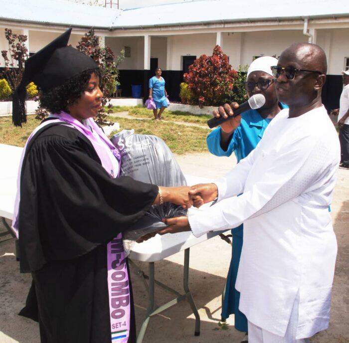 A SoMBo midwife graduate receives her Seed-provided essential midwife kit on graduation day.