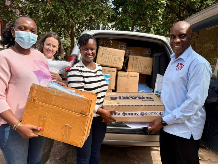 Deputy Executive Director for Mulago National Referral Hospital Dr. John Sekabira receiving a PPE delivery from Seed country director Irene Atuhairwe and Seed educators Dr Mary Ellen Lyon and Dr Doreen Alalait Okong.