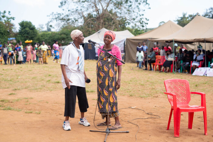 Members of the community enacting a scene on accessing pre-natal care during a community-centred maternity care open day in Sumbuleta Village, Malawi.